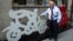 Mexican artist Gilberto Aceves Navarro poses for a portrait with two of his bicycle sculptures in New York City, June 30, 2014.