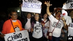 Supporters of former President Alberto Fujimori celebrate his medical pardon outside the clinic where the jailed leader was admitted the previous day after suffering a drop in blood pressure in Lima, Peru, Sunday, Dec. 24, 2017.