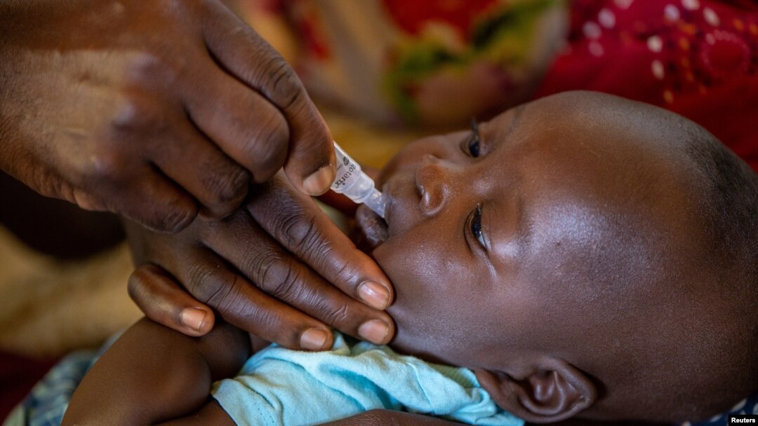 FILE - A child receives an oral Malaria vaccine at Chileka Health Center, in Lilongwe, Malawi in this undated handout photo from UNICEF.