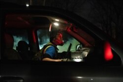 A protester wears a gas mask while confronting police in front of the Brooklyn Center Police station on April 11, 2021, in Minnesota.