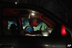 A protester wears a gas mask while confronting police in front of the Brooklyn Center Police station on April 11, 2021, in Minnesota.