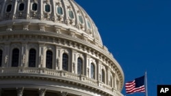 FILE - The U.S. flag flies over the U.S. Capitol in Washington, Jan. 19, 2020.