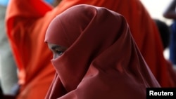 A Somali refugee waits to board a U.N. plane bound for Somalia, part of the UN's Voluntary Repatriation program, in the Dadaab refugee camp, Kenya, Dec. 19, 2017.