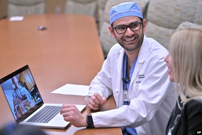 Dr. Rohaid Ali plays a video from a high school project made by his patient Alexis Bogan on Thursday, March 11, 2024, at Rhode Island Hospital in Providence, R.I. (AP Photo/Josh Reynolds)