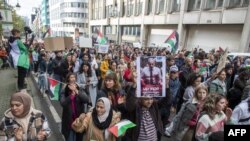 FILE - Demonstrators attend a rally called 'Gaza: stop massacres, stop impunity' in support of Palestinians and to demand for an immediate ceasefire, in Brussels, on October 22, 2023.