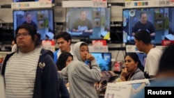 Shoppers stand in a checkout line during Black Friday sales at a Target store in Culver City, California, Nov. 25, 2016.