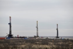 FILE - Drilling rigs operate in the Permian Basin oil and natural gas production area in Lea County, New Mexico, U.S., February 10, 2019. (REUTERS/Nick Oxford)