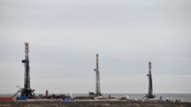 FILE - Drilling rigs operate in the Permian Basin oil and natural gas production area in Lea County, New Mexico, U.S., February 10, 2019. (REUTERS/Nick Oxford)
