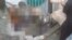 WARNING GRAPHIC FOOTAGE: A mob kills a woman and sets her body alight for allegedly burning a copy of the Quran near the Shah-e Doh Shamshira shrine in Kabul, March 19, 2015. (RFE/RL's Radio Free Afghanistan) 