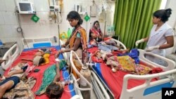 Children showing symptoms of encephalitis undergo treatment at Sri Krishna Medical College Hospital in Muzaffarpur, Bihar state, India, June 18, 2019.