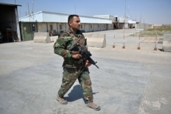 An Afghan National Army soldier walks inside the Italian Camp Arena military base after Italian forces left the camp in Guzara district of Herat province, June 30, 2021.