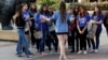 FILE - In this Feb. 26, 2015, file photo, UCLA campus tour guide Samantha St. Germain, center, a bioengineering student, leads prospective college-bound high school seniors on a campus tour in Los Angeles. 