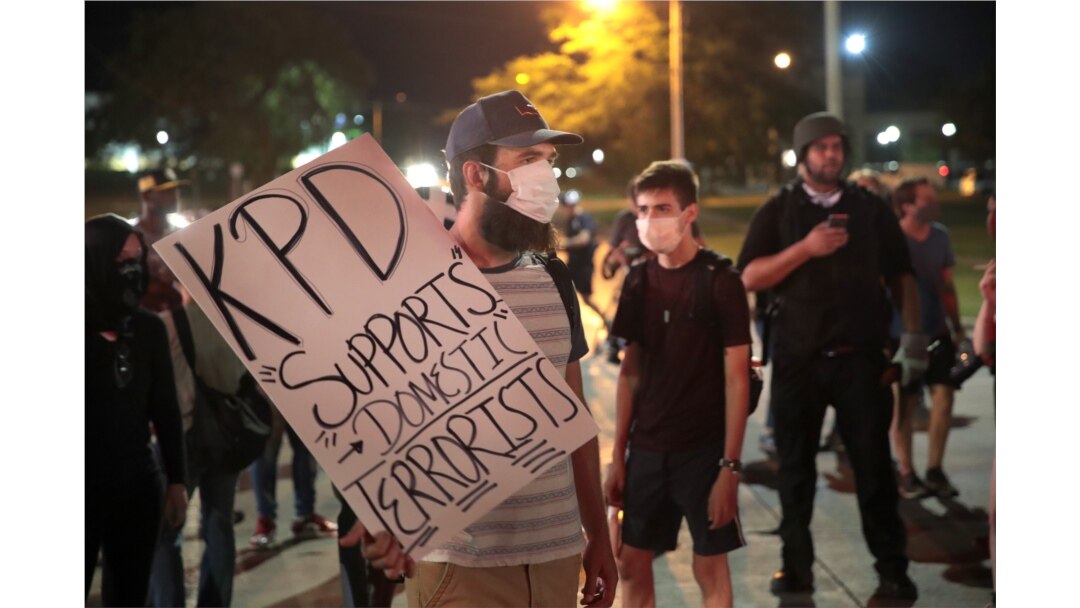FILE - Demonstrators protests the shooting of Jacob Blake in Kenosha, Wisconsin, Aug. 26, 2020.