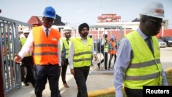 FILE: U.S. nominee to head World Bank, Ajay Banga walks with officials during his visit at the headquarters of Ivorian electricity company of Yopougon in Abidjan, Ivory Coast. Taken Mar. 7, 2023. 