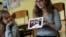 Jewish teenager Sophie Steiert, right, shows a picture of Jewish daily life on a tablet computer as Laura Schulmann looks on during a lesson as part of a project of religions at the Bohnstedt Gymnasium high school in Luckau, Germany, June 25, 2018.