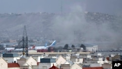 FILE - Smoke rises from a deadly explosion outside the airport in Kabul, Afghanistan, on Aug. 26, 2021, as the U.S. withdrawal from the country began.