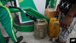 FILE: People buy fuel at a petrol station in Lagos, Nigeria, Friday, Feb. 18, 2022. The World Bank funding for social programs is meant to offset the impact of the government's move away from petrol subsidies. 