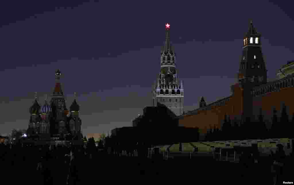 A view shows the St. Basil's Cathedral, left, and the Kremlin wall, after the lights were switched off for Earth Hour in Red Square in central Moscow, Russia, March 25, 2017.