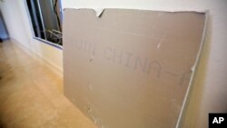 FILE - A large chunk of Chinese drywall from the Alfonso Sanchez home in Davie, Fla. leans against the wall, Oct. 15, 2009.