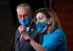 FILE - House Speaker Nancy Pelosi, D-Calif., and Senate Minority Leader Chuck Schumer, D-N.Y., meet with reporters on Capitol Hill in Washington, Nov. 12, 2020.