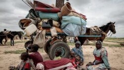 FILE PHOTO: A Sudanese family who fled the conflict in Murnei in Sudan's Darfur region, sit beside their belongings while waiting to be registered by UNHCR upon crossing the border between Sudan and Chad in Adre, Chad, July 26, 2023. 