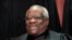 FILE - Justice Clarence Thomas sits with fellow Supreme Court justices for a group portrait at the Supreme Court Building in Washington, Nov. 30, 2018. 