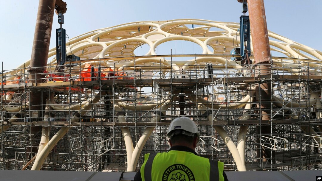 In this Oct. 8, 2019 photo, an employee of the Dubai Expo 2020 visits the Al Wasl Dome at the under construction site of the Expo 2020 in Dubai, United Arab Emirates. 