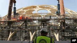 In this Oct. 8, 2019 photo, an employee of the Dubai Expo 2020 visits the Al Wasl Dome at the under construction site of the Expo 2020 in Dubai, United Arab Emirates. 