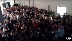 This frame grab from Nasa, shows employees and guests reacting as the Intuitive Machines' Odysseus lunar lander touches down on the moon, in Torrance, California, on February 22, 2024. (Photo by Handout / NASA / AFP)