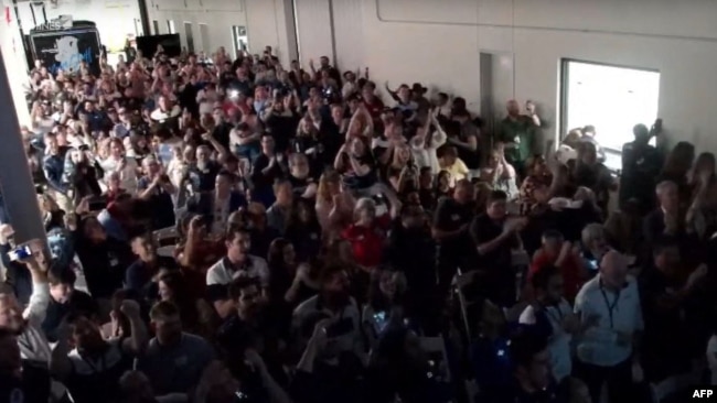 This frame grab from Nasa, shows employees and guests reacting as the Intuitive Machines' Odysseus lunar lander touches down on the moon, in Torrance, California, on February 22, 2024. (Photo by Handout / NASA / AFP)