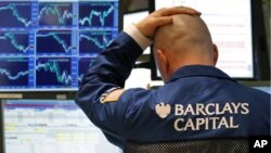 A trader watches his screen on the floor of the New York Stock Exchange. U.S. stocks dropped for a second straight session as Libya's violence sent oil prices up briefly to $100 a barrel and tech shares sank, February 23, 2011.