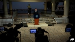 With a bust of Latin America's independence hero Simon Bolivar in the background, Panama's President Juan Carlos Varela gives a televised statement to the nation, in Panama City, Wednesday, April 6, 2016.