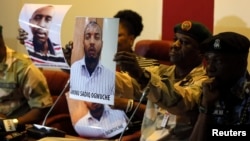 Photographs of Rufai Abubakar Tsiga (L) and Aminu Sadiq Ogwuche are presented to the media by the State Security Service in Abuja, Nigeria, May 12, 2014.