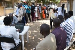 Residents wait in line to register in order to receive their first dose of the AstraZeneca Covid-19 vaccine, during a mass vaccination drive at the Dandora Health Center in Nairobi on Aug. 10, 2021.