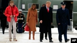 President Donald Trump walks with his wife, Melania, and their son Barron at Andrews Air Force Base, Md., to switch from Marine One to Air Force One for a flight to Florida, where they planned to spend the weekend at their Mar-a-Lago estate in Palm Beach, Feb. 1, 2019.