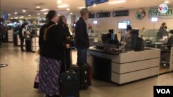 Migrantes pasan por control migratorio, en el Aeropuerto Internacional El Dorado, en Bogotá.