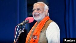 Hindu nationalist Narendra Modi, who will be the next prime minister of India, addresses Gujarat state lawmakers and party workers during the appointment of the state's new chief minister in Gandhinagar, May 21, 2014.