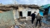 FILE - In this photo released by VORONEZH NEWS telegram channel on April 18, 2024, local citizens stand near a house damaged by a Ukrainian drone attack in Voronezh, Russia. 