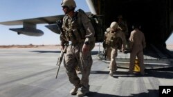 FILE - U.S. Marines are seen disembarking from a C-130 transport plane.