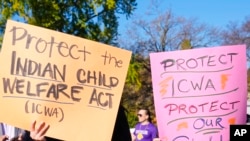 Demonstrators stand outside the U.S. Supreme Court in Washington, Nov. 9, 2022, as the court hears arguments over the Indian Child Welfare Act. AP Photo/Mariam Zuhaib.