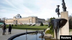 FILE -- A modern sculpture by Belgian artist Tom Frantzen shows former Belgian King Leopold II surrounded by animals and African warriors in the park of the Royal Museum for Central Africa in Tervuren, Belgium, Jan. 22, 2014. After a five-year remodel, it reopened, Dec. 8, 2018.