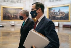 Treasury Secretary Steven Mnuchin and White House chief of staff Mark Meadows, left, walk to House Speaker Nancy Pelosi's office on Capitol Hill in Washington, Aug. 5, 2020.