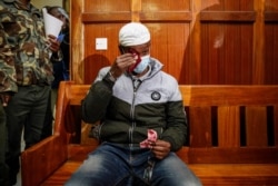 Liban Abdullah Omar, who was found innocent of supporting the gunmen involved in the Westgate Mall attack in Sept. 2013, reacts after the verdict is delivered at Milimani court in Nairobi, Kenya, Oct. 7, 2020.