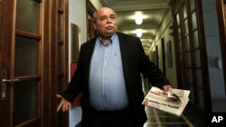 Greek Minister of Interior and Administrative Reconstruction Nikos Voutsis arrives for a cabinet meeting at the parliament in Athens, May 12, 2015. 