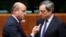 Spain's Economy Minister Luis de Guindos talks to European Central Bank (ECB) President Mario Draghi (R) during a eurozone finance ministers meeting in Brussels, Dec. 17, 2013.