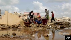 People whose houses were demolished on public health grounds collect water in the Gesco neighborhood of Abidjan, Ivory Coast, Feb. 28, 2024. Rapid urbanization has led to a population boom and housing shortages in Abidjan, where nearly one in five Ivorians reside.