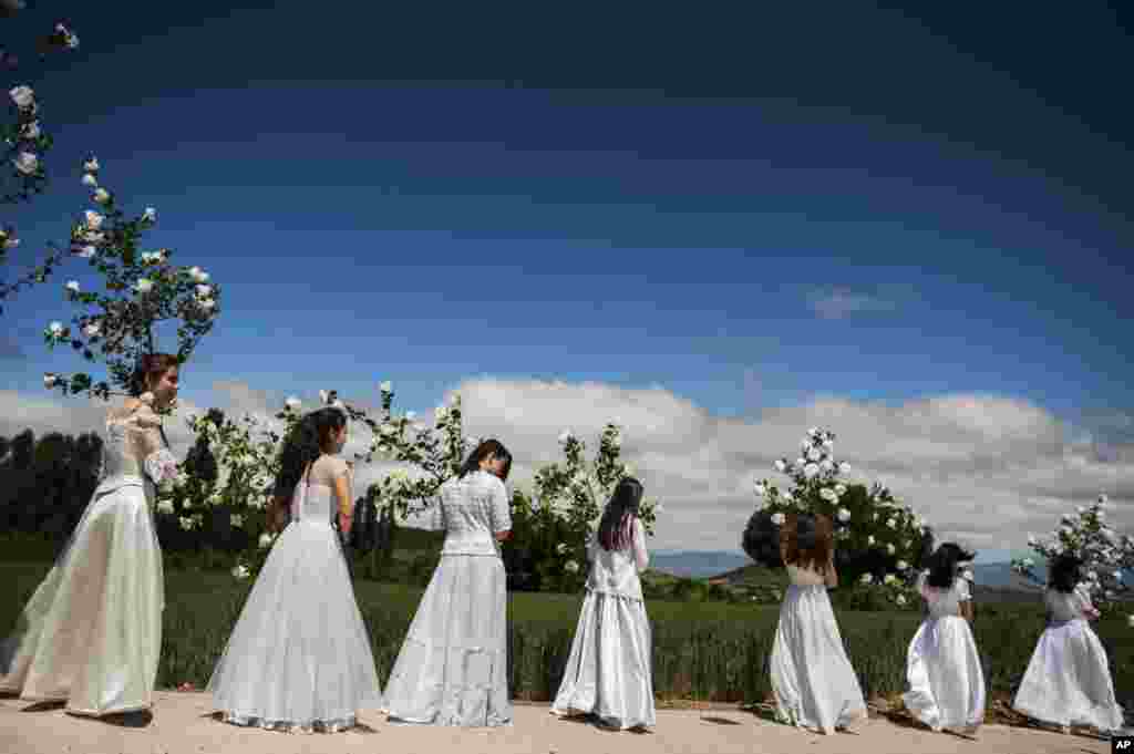 Teenagers dressed in bridal white surrounded by flowers, take part in the pilgrimage &quot;The Hundred Maidens&quot;, in Sorzano, northern Spain.