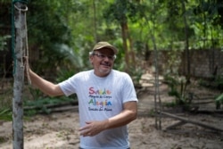 FILE - Caetano Scannavino, coordinator of NGO Saude e Alegria, or Health and Happiness, gives an interview outside his home in Alter do Chao, Para state, Brazil, Dec. 1, 2019.