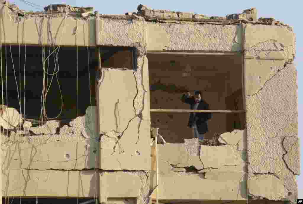 An Egyptian plainclothes policeman stands in the damaged national security building after a bomb exploded in the Shubra el-Kheima neighborhood of Cairo, injuring several people according to Egyptian security officials,&nbsp;early Aug. 20, 2015.