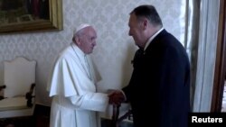 U.S. Secretary of State Mike Pompeo shakes hands with Pope Francis on the sidelines of a symposium at the Vatican, October 3, 2019 in this still image taken from a video.